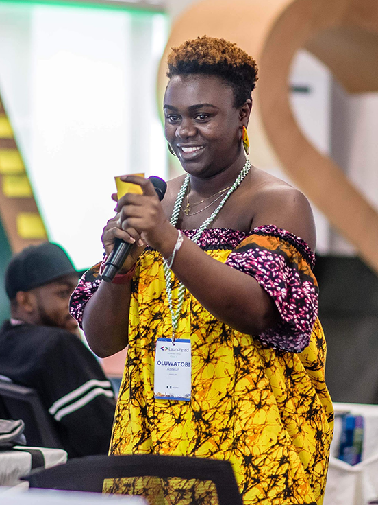 The female host, with a mic in hand, is delivering an excellent event.