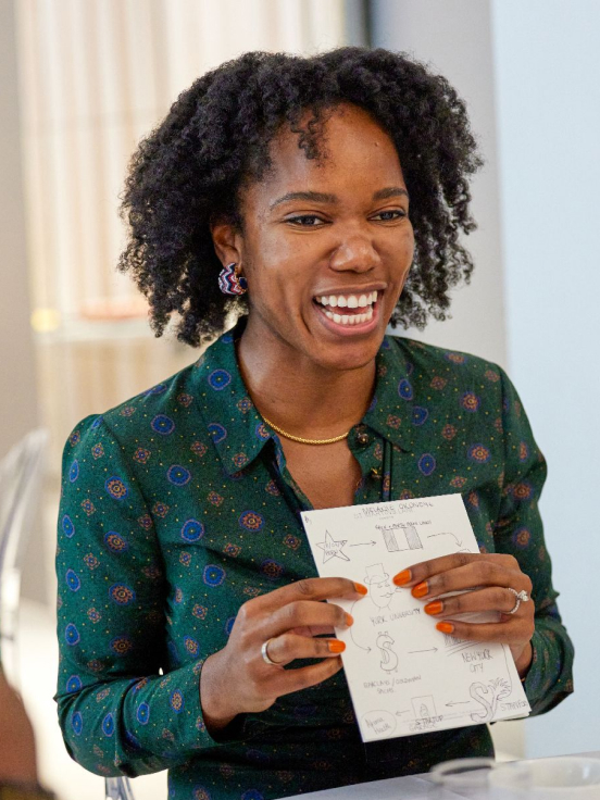 A woman have paper in hand and is laughing