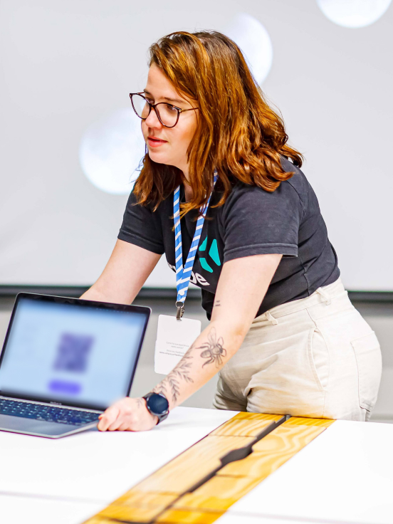 A woman showing something on Laptop