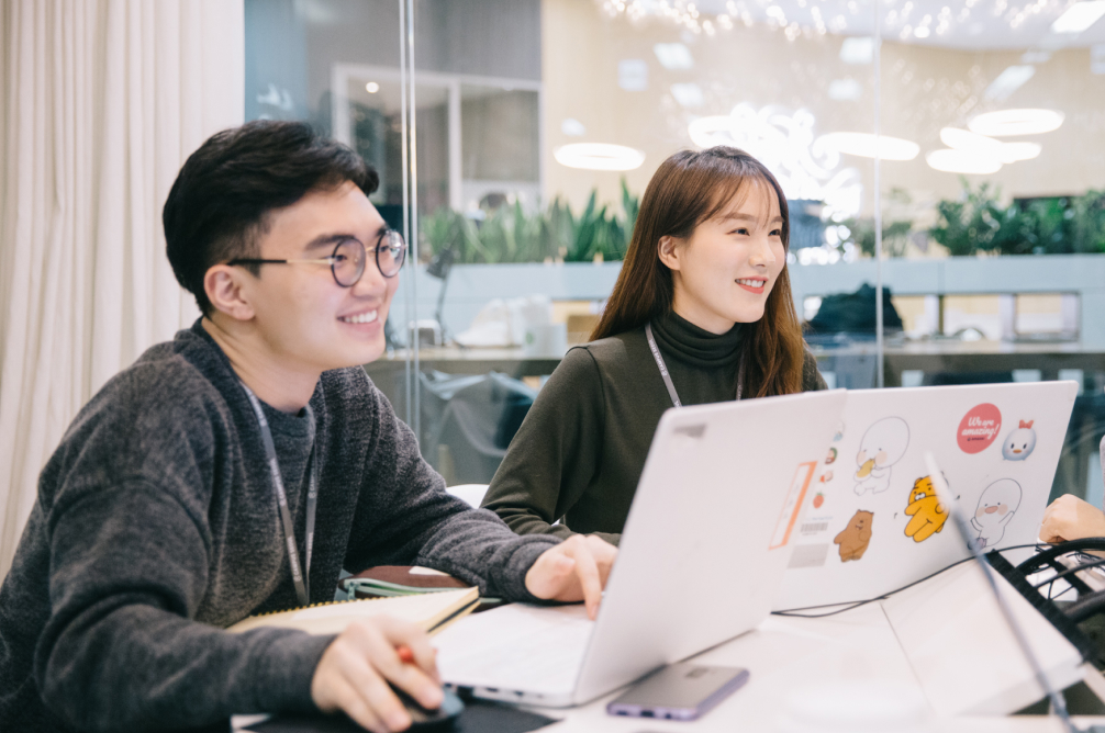 A man and woman looking at something.
