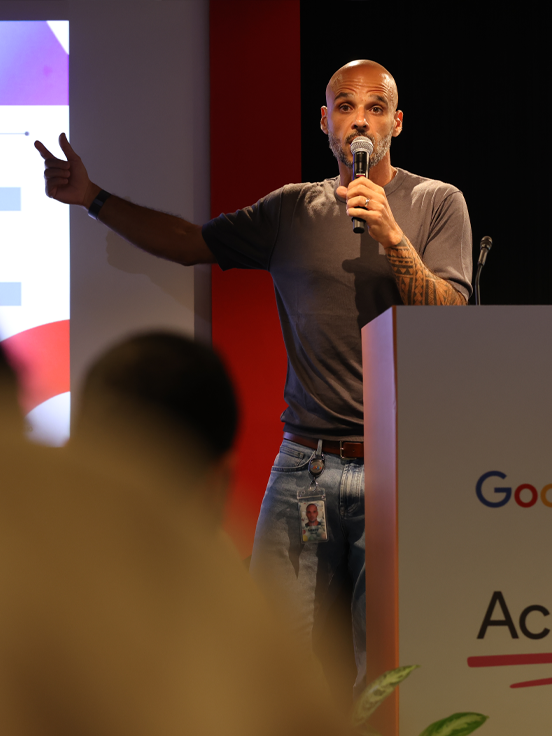 A person is hosting the event and currently speaking into the microphone.