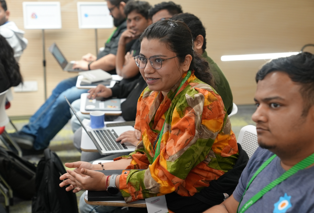 A girl with specs smiling and looking cross.