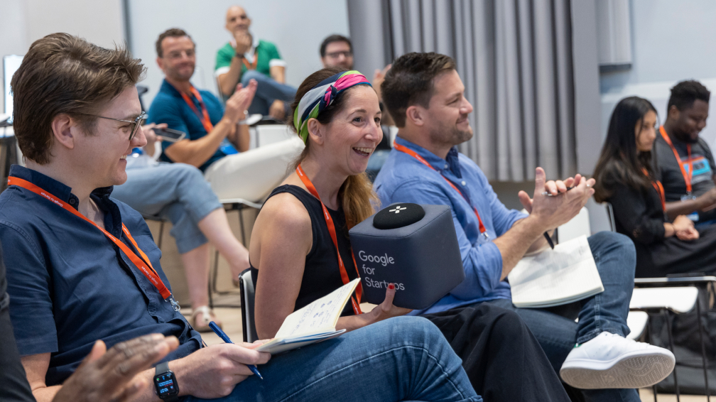 group of people sitting on chairs and applauding during therapy