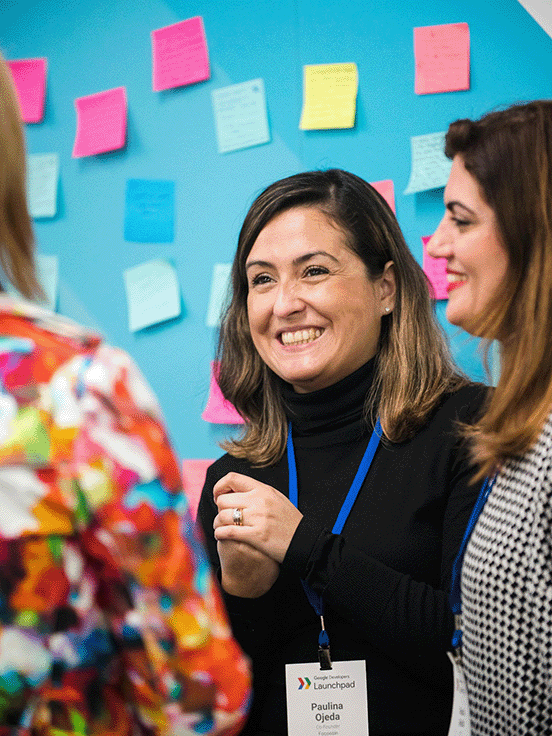 The volunteer lady is instructing a group of women at the stall.