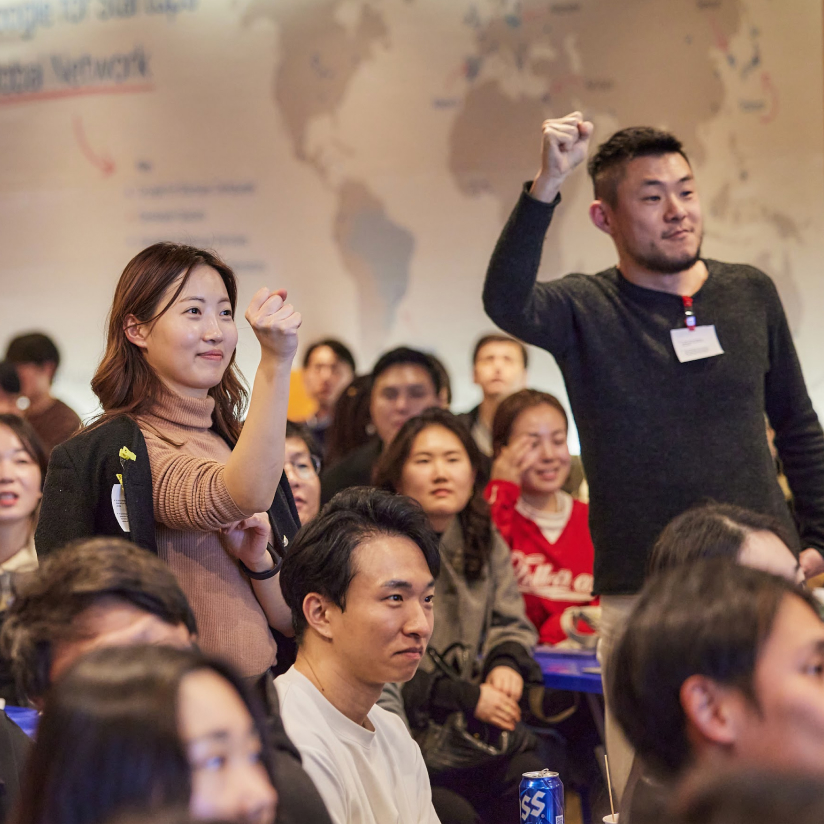 Student raising hand and cheerful pointing to them