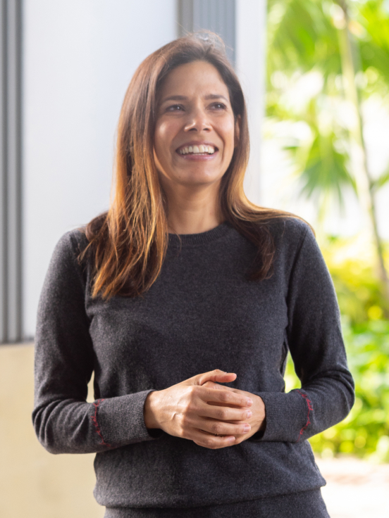 Woman smiling and facing the camera.