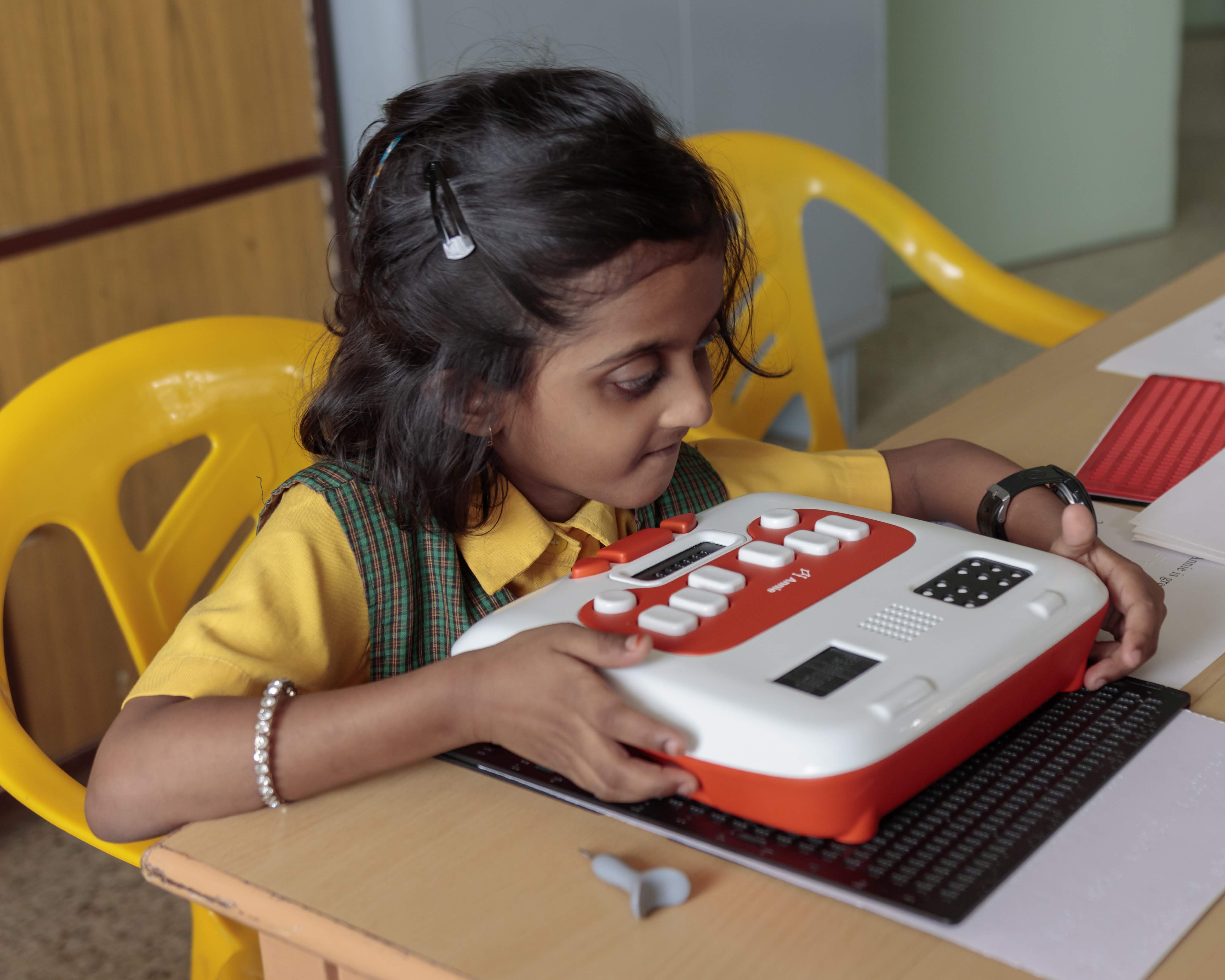 Young girl student learns Braille on Annie, an edtech device from Thinkerbell Labs