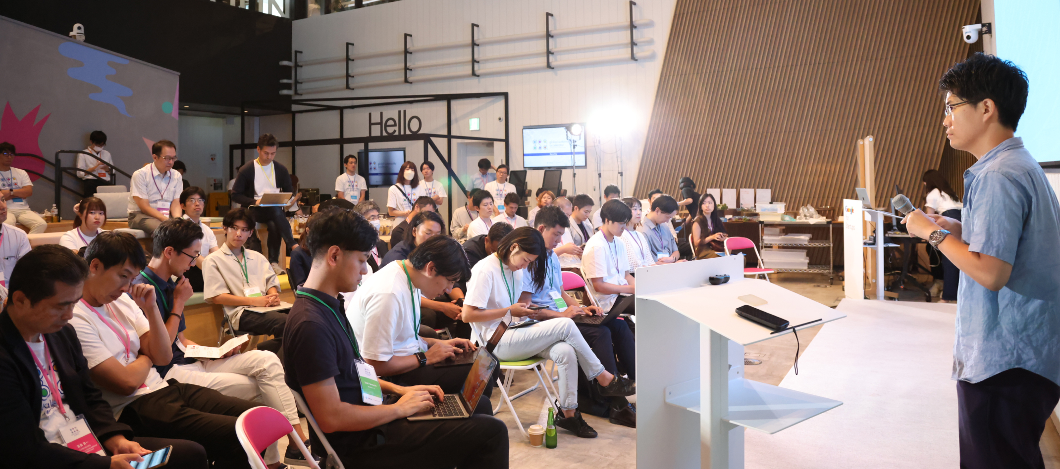 Group Of Modern People Sitting With Laptops And Mobile Phones In seminar hall