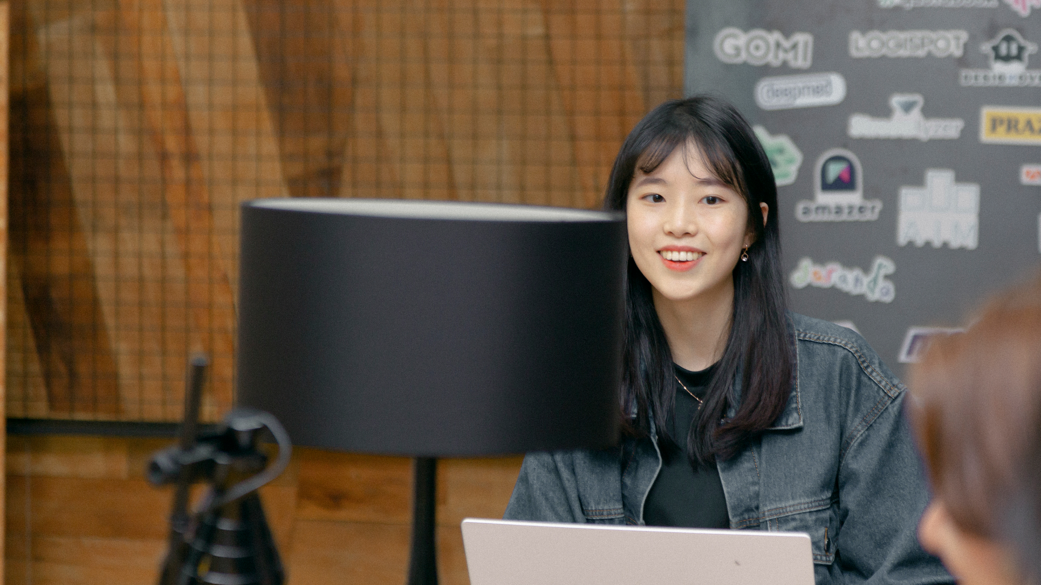 Jeonghyun Yoon, CEO of BlueSignum is looking into laptop and smiling.