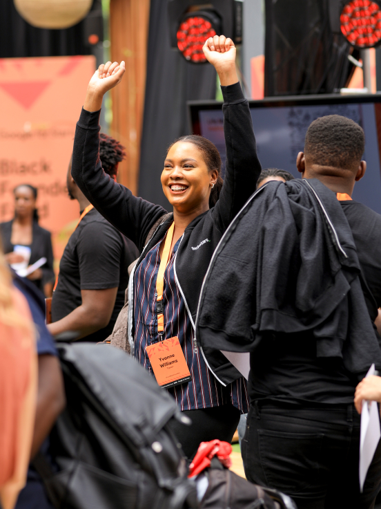 A woman with standing hands laughing.