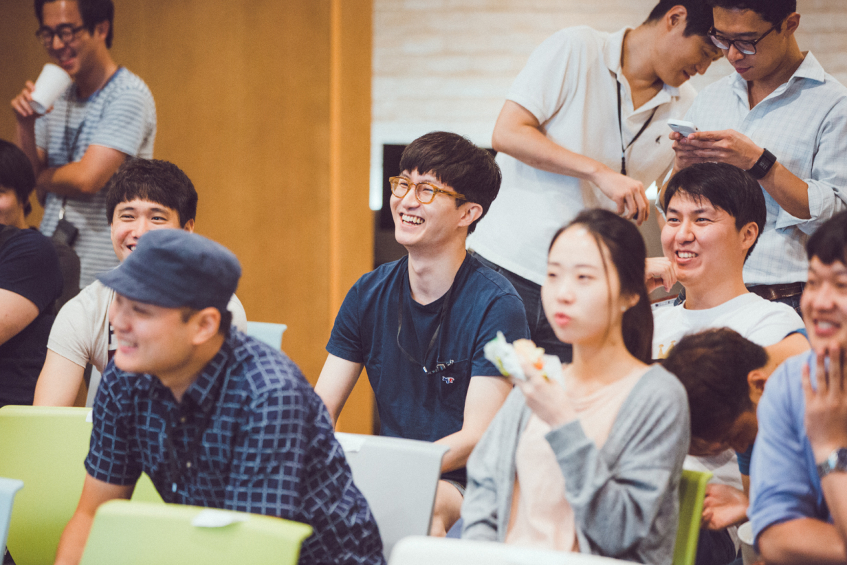 Smiling Audience Listening to Seminar