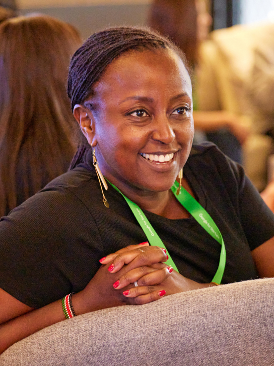 A woman sits on a chair.