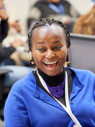 Lady in blue jacket is smiling.