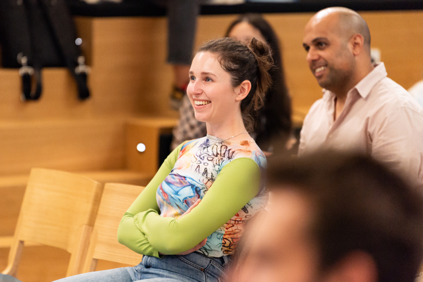 A woman is smiling while looking in front of her.