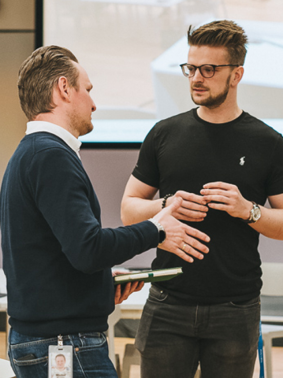 Two men and a woman discussing something.