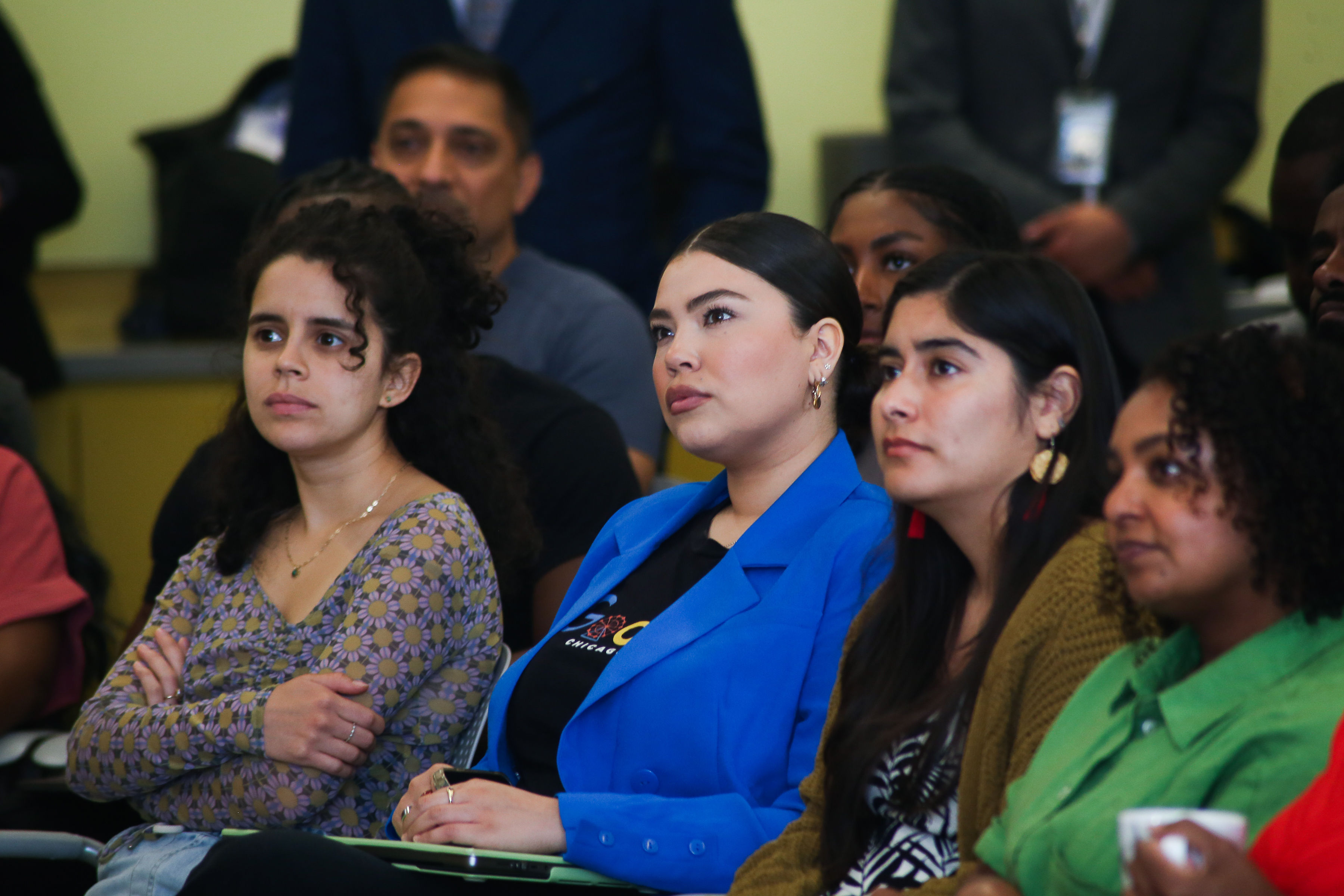 Four women listening to someone