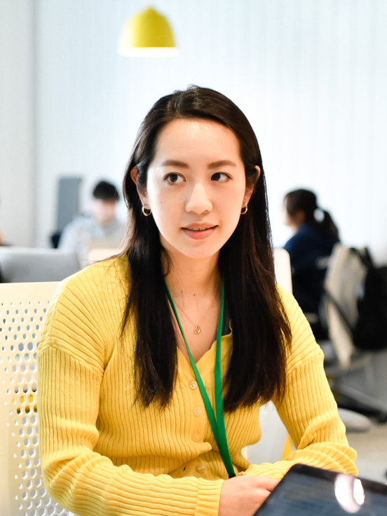 A lady in yellow top with icard.