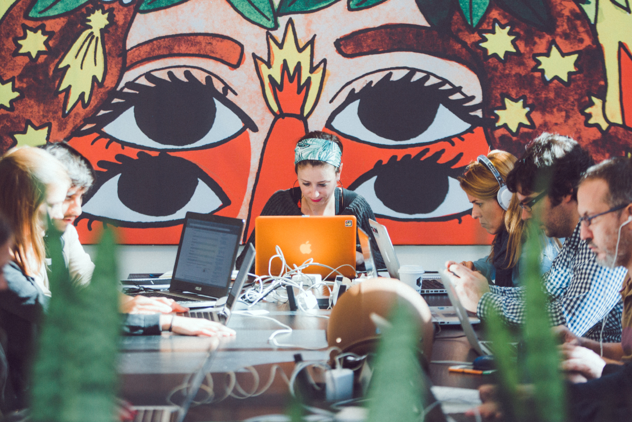 A group of people working on laptop