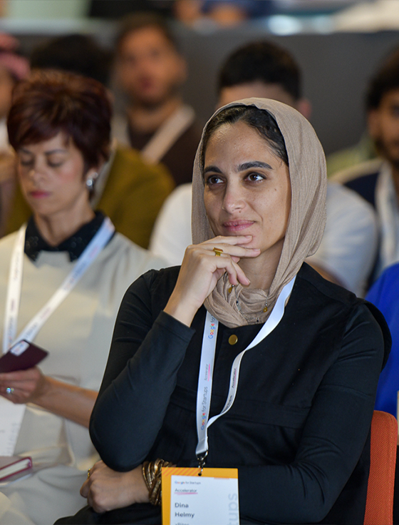 The lady in the scarf is giving her rapt attention to the event.