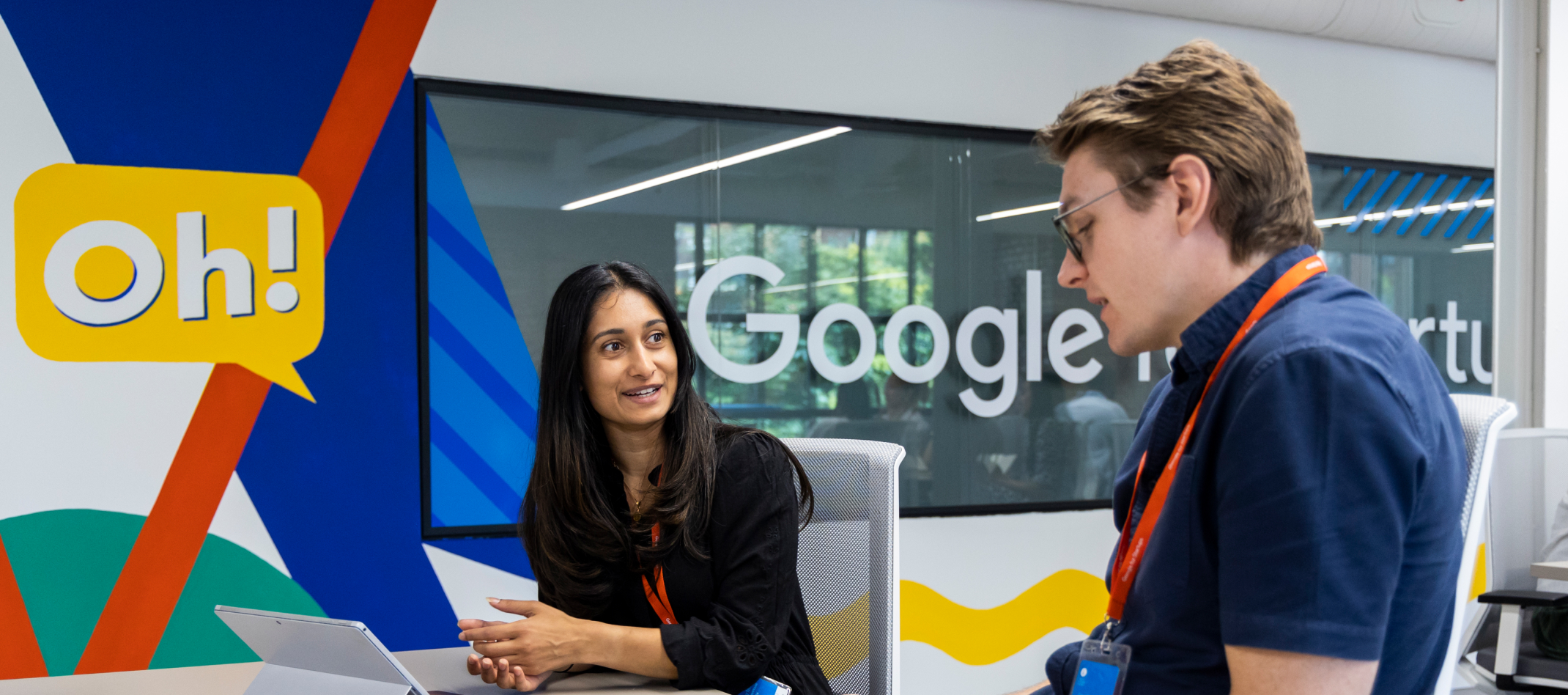 A man and women discussing something on a table.