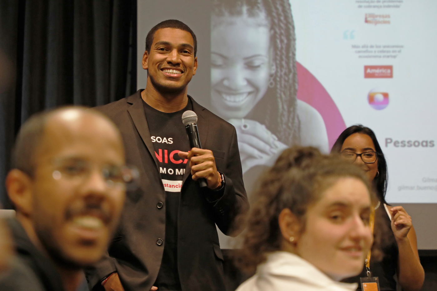 A man holding mic in hand and smiling