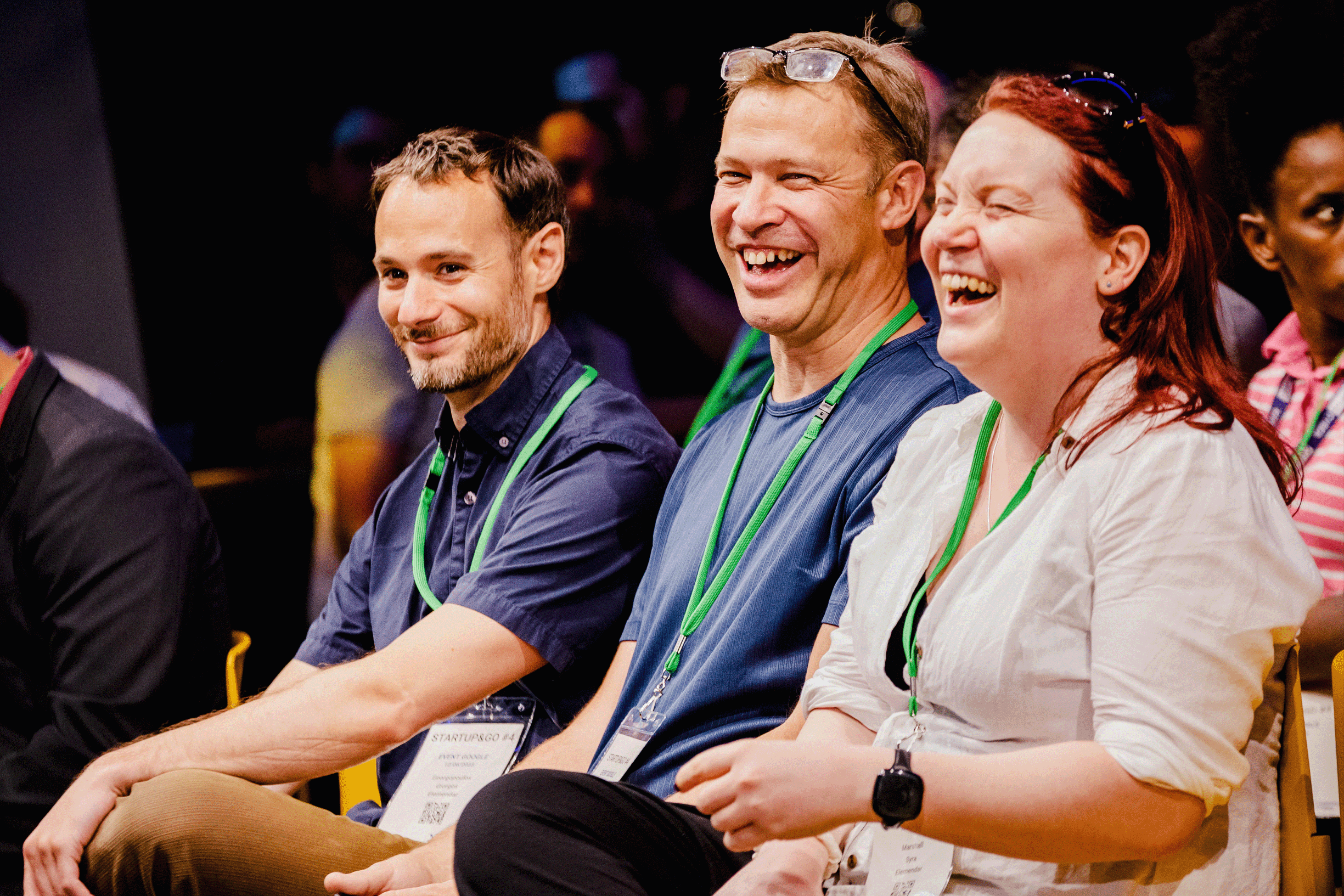A group of people laughing while sitting.