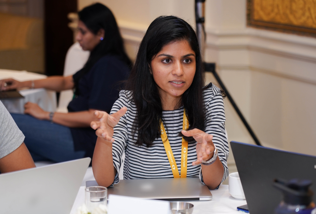 A woman explains something to others