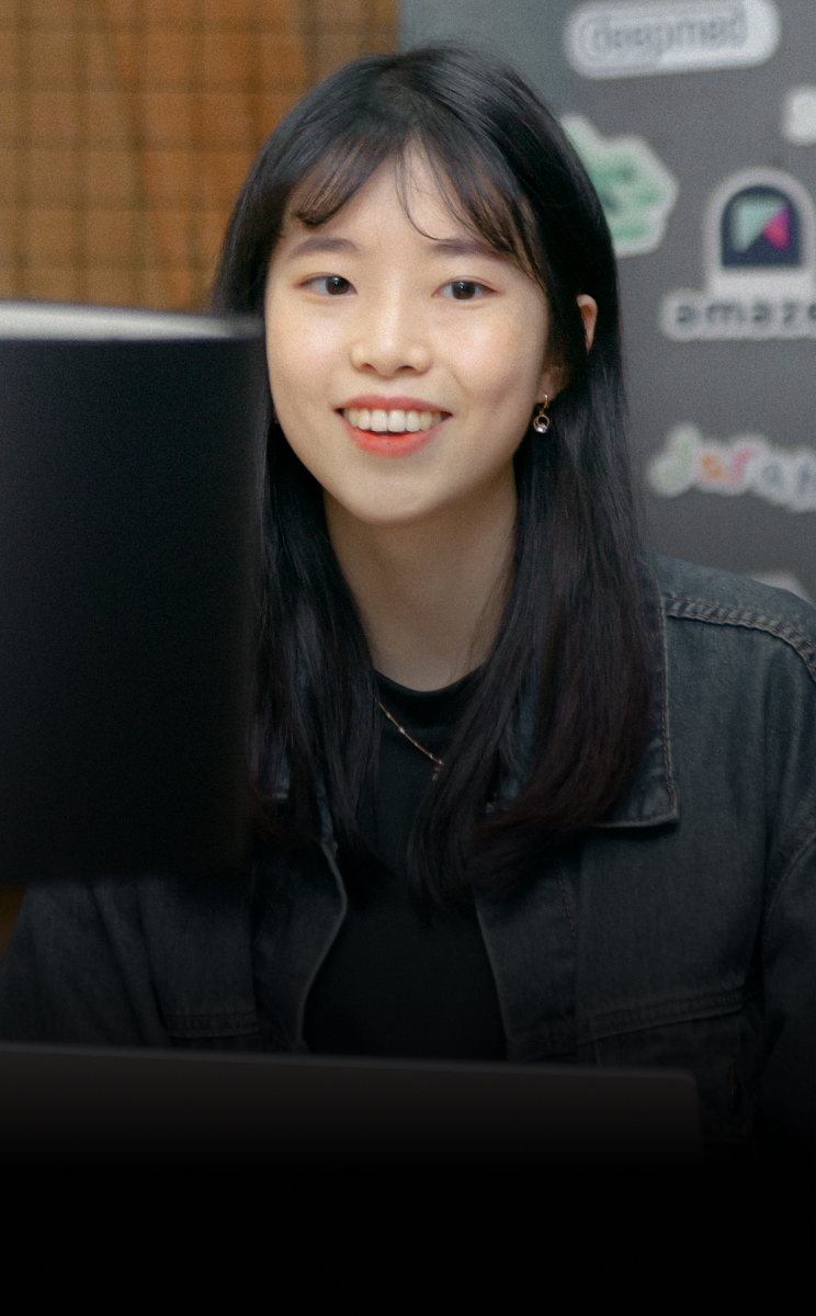 Jeonghyun Yoon, CEO of BlueSignum is looking into laptop and smiling.