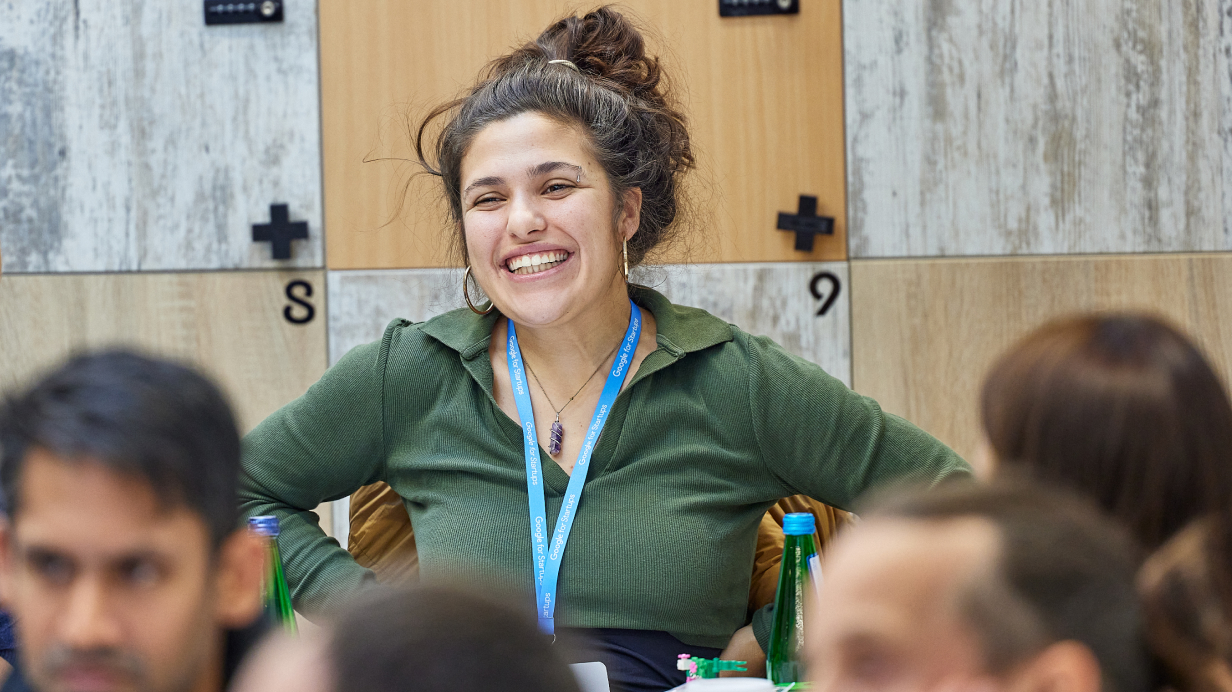 A smiling woman in focus in group of people