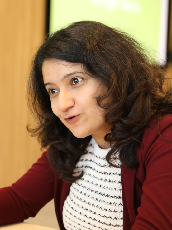 A woman wear red jacket.