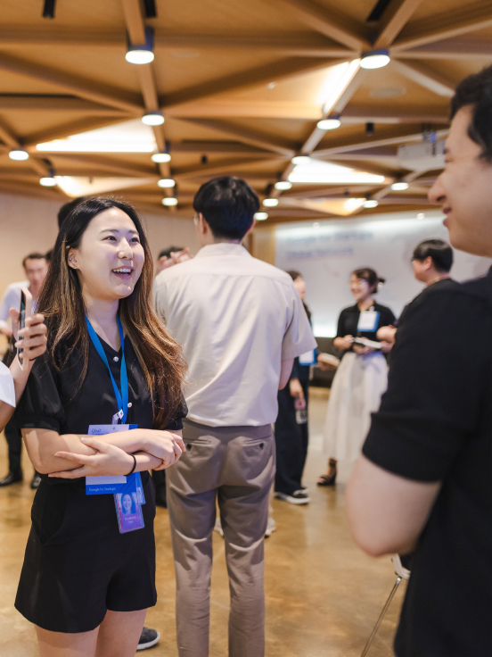 Woman smiling and discussing with a man.